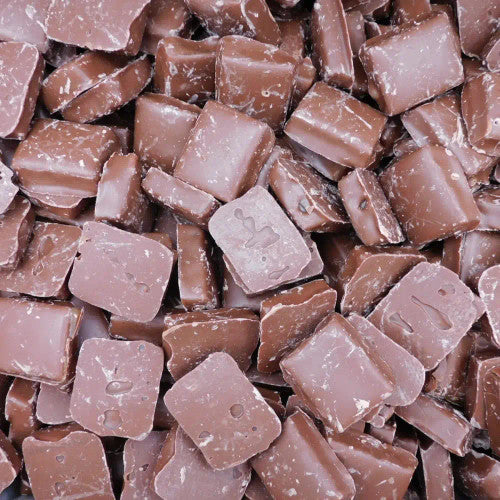 Assorted milk chocolate squares and rectangles with sea salt crystals scattered on top, arranged in a dense pattern