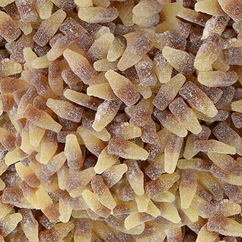 Sour cola bottle-shaped gummy candies in brown and amber colors covered in sugar crystals, showing classic bottle shapes with tangy coating
