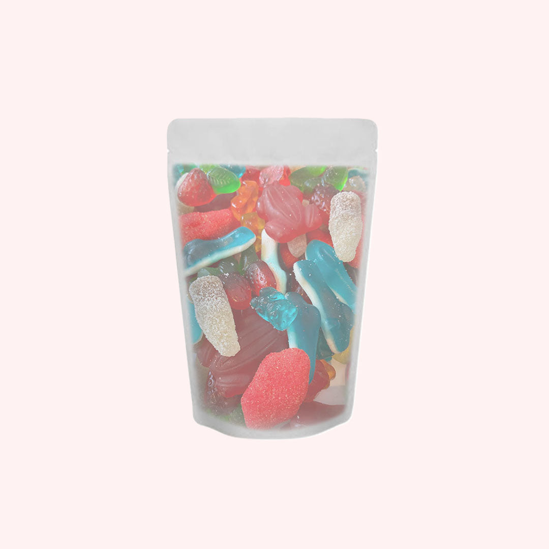 Mixed gummy candy variety pack in transparent stand-up pouch featuring colorful gummy sharks, worms, and assorted shapes in red, blue, green, pink, and clear colors