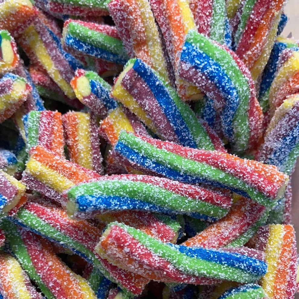 Colorful sour rainbow twists candy covered in sugar crystals, showing twisted strips in vibrant colors including red, orange, yellow, green, blue, and purple arranged in a pile