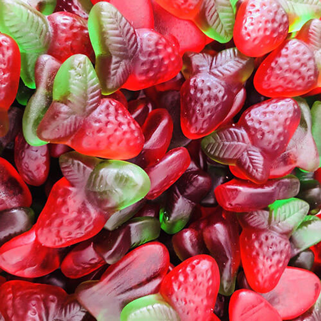 Strawberry leafs gummy candy in red strawberry shapes and green leaf shapes with detailed textures, showing realistic strawberry and leaf designs