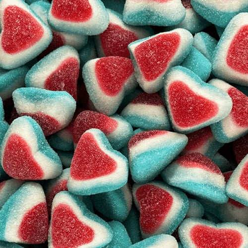 Triple heart-shaped gummy candies in red, white, and blue colors with sugar coating, showing three connected hearts in patriotic or romantic color scheme scattered across the frame