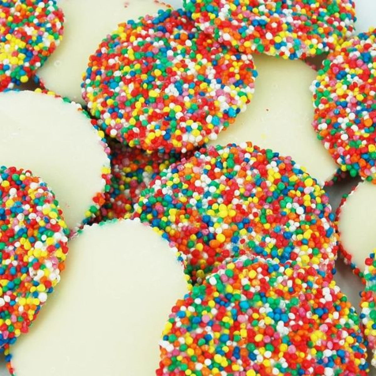 400g white chocolate jewels with colorful freckles and polka dots scattered on white background